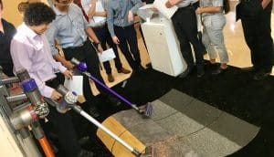 Customers trying out Dyson vacuum cleaners